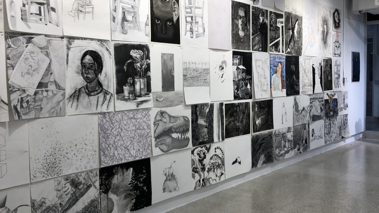 long shot of the exhibit wall with many student drawings
