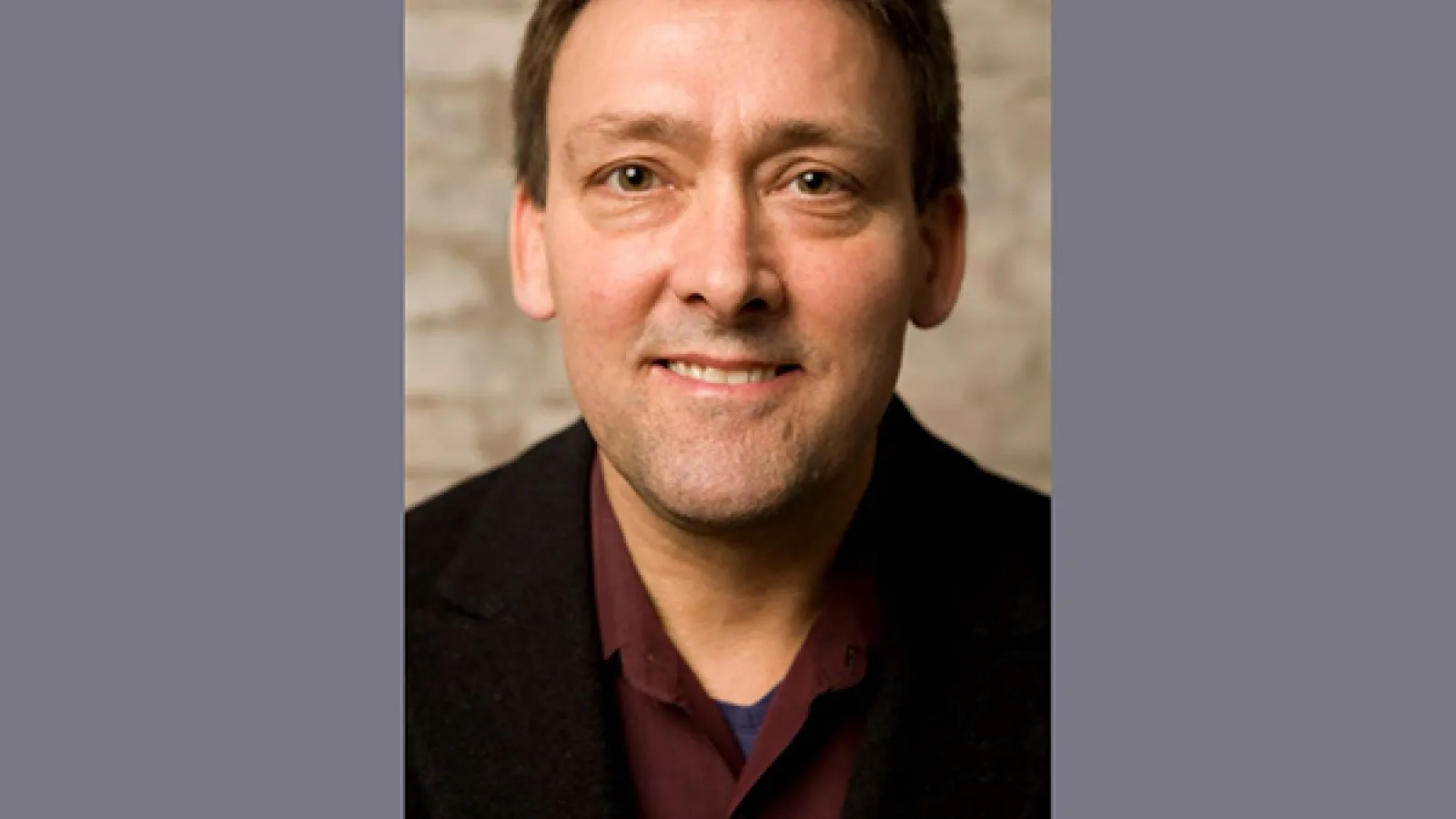 Ken Rinaldo - a smiling man with dark hair looking directly into the camera