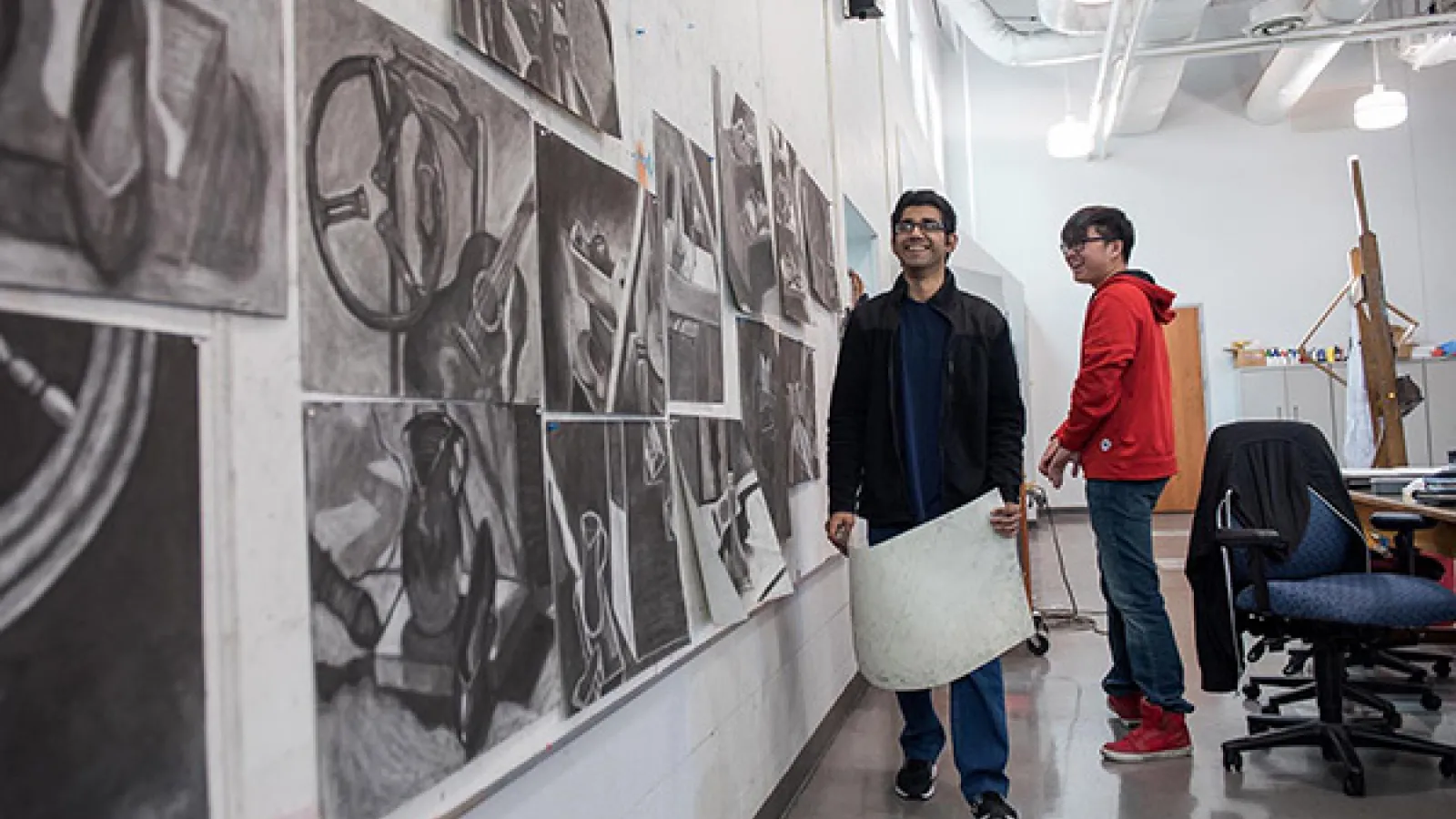 Students hanging drawings