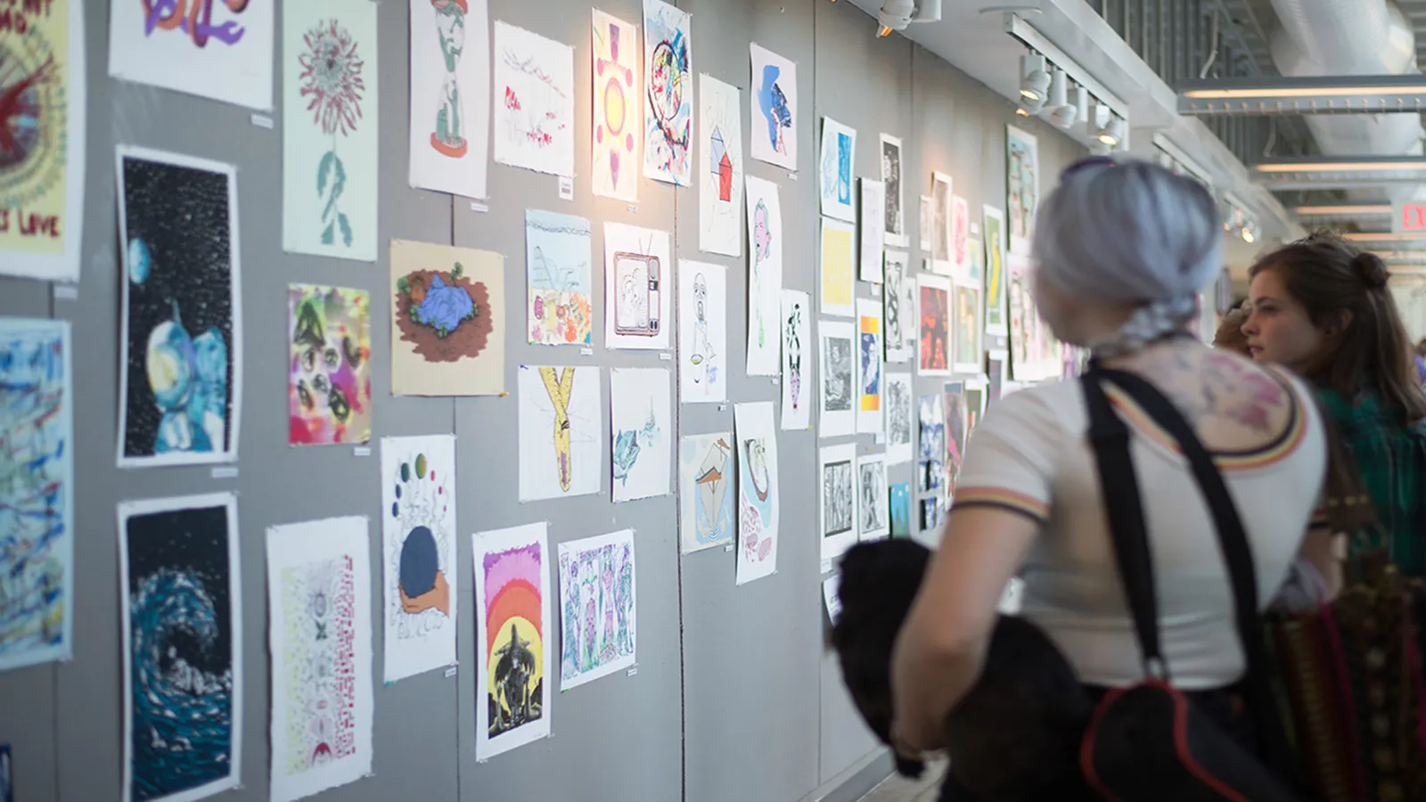 Visitors viewing student work at an open house event
