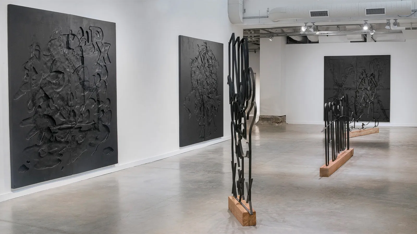 Instillation view of exhibition to include three large paintings and three large metal and wood sculptures. 