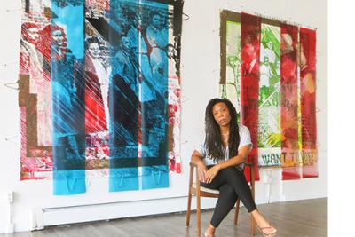 Tomashi Jackson seated in front of artwork