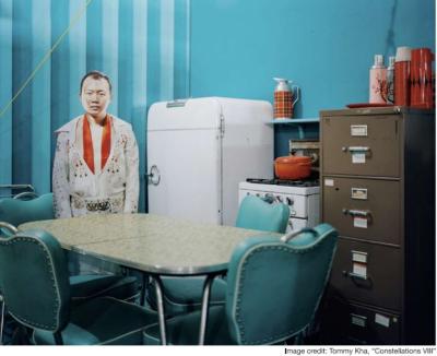 man dressed in Elvis outfit standing in retro kitchen