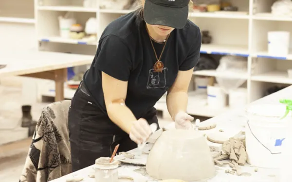 Student making bowl