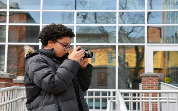 student with camera