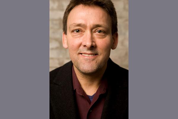 Ken Rinaldo - a smiling man with dark hair looking directly into the camera