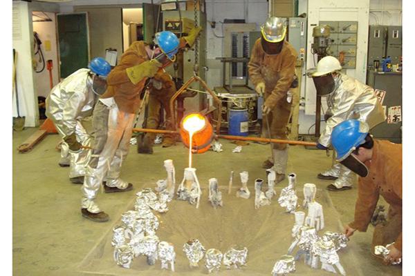 Students working with hot metal
