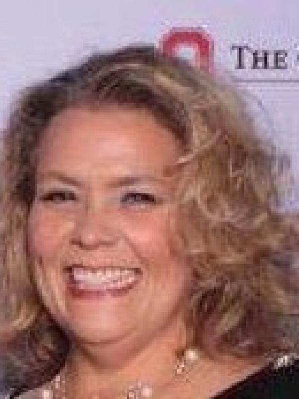 a smiling white woman with blonde hair,