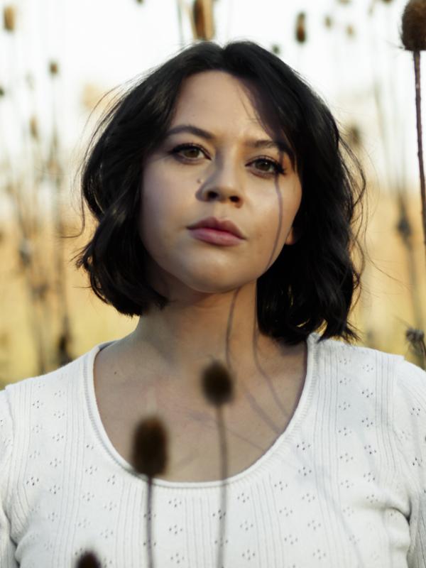 a person with shoulder length black hair, brown eyes
