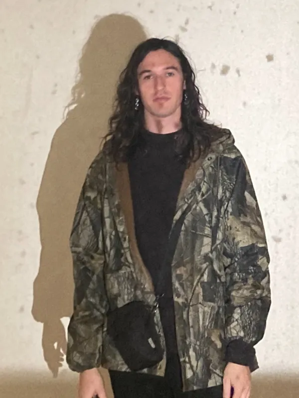 a person standing front of a wall