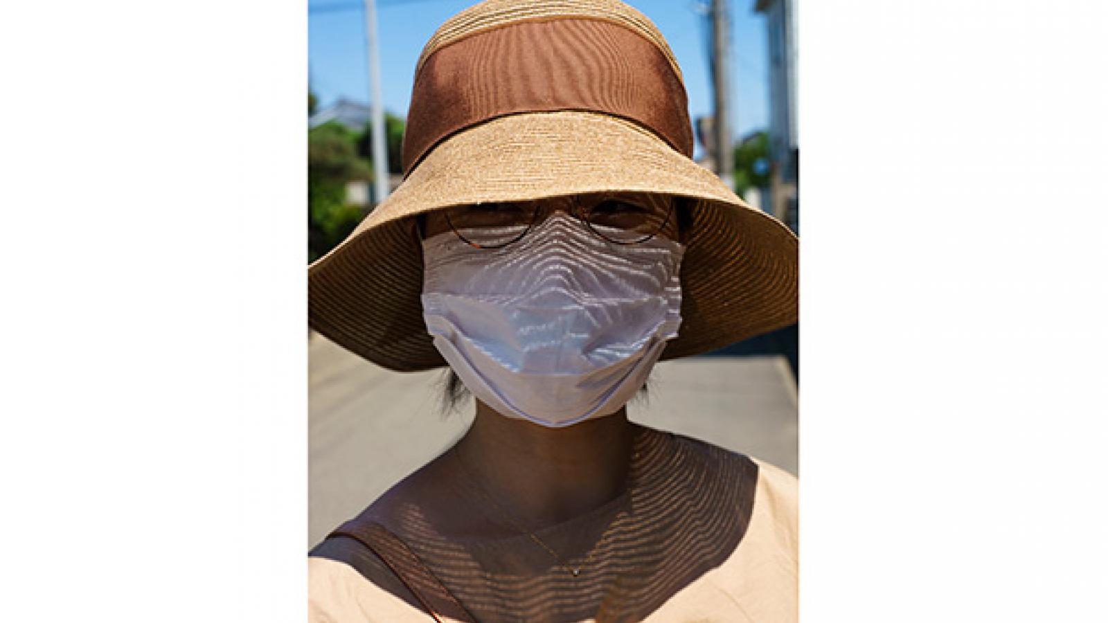 person in sunhat and face mask