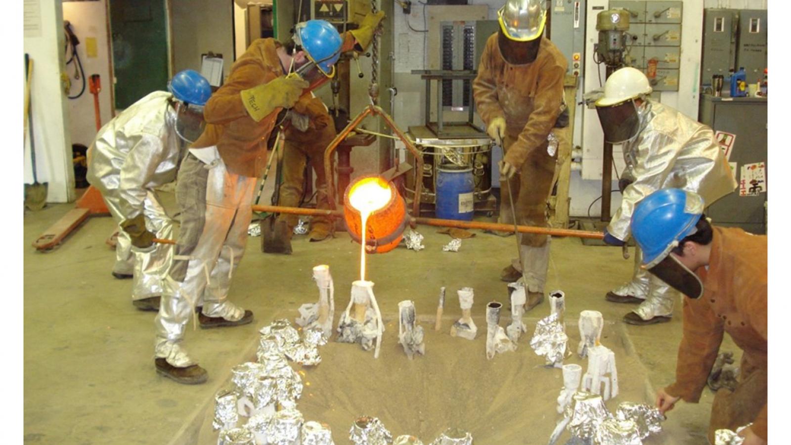 Students working with hot metal