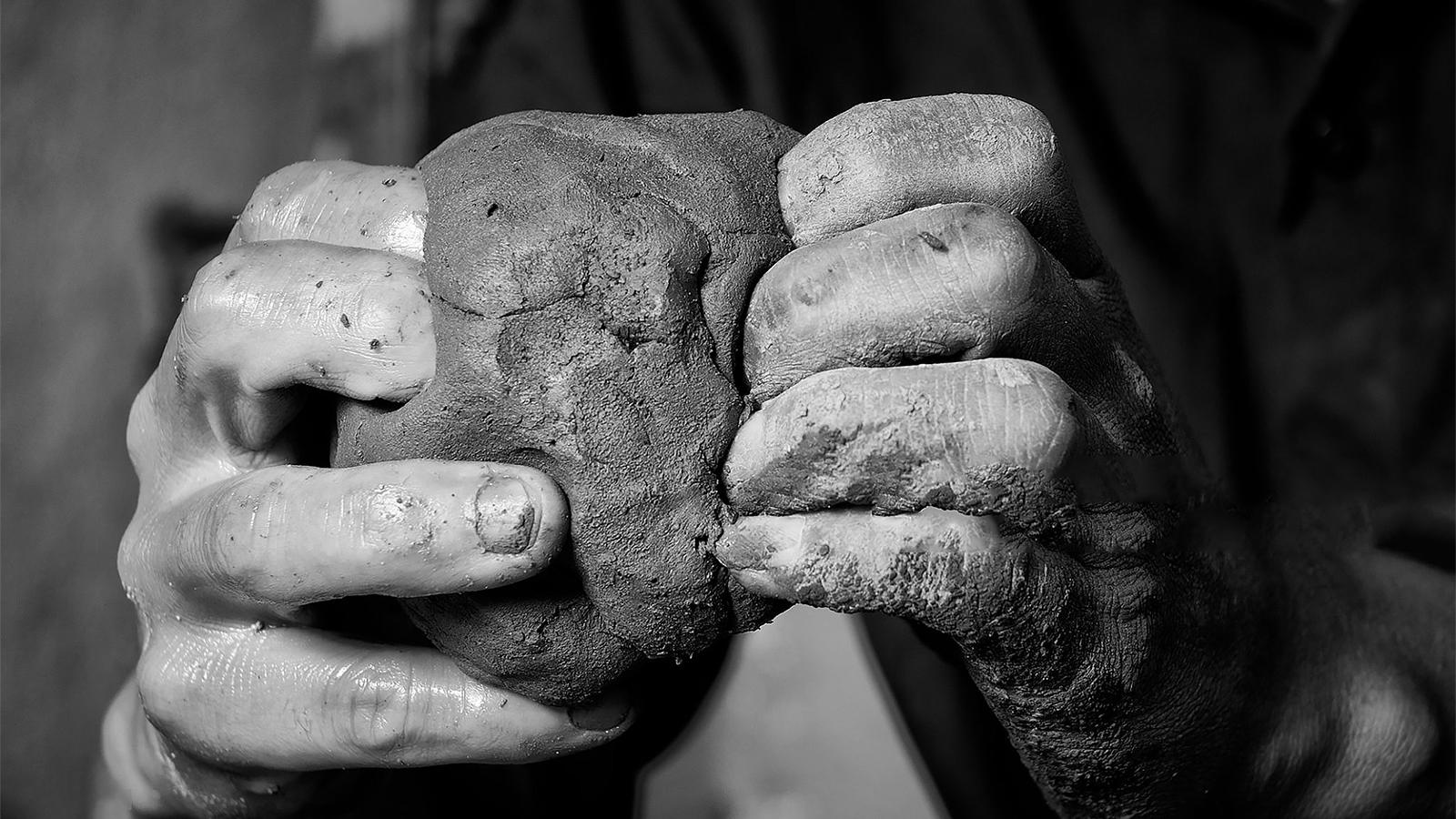 image of hands working clay
