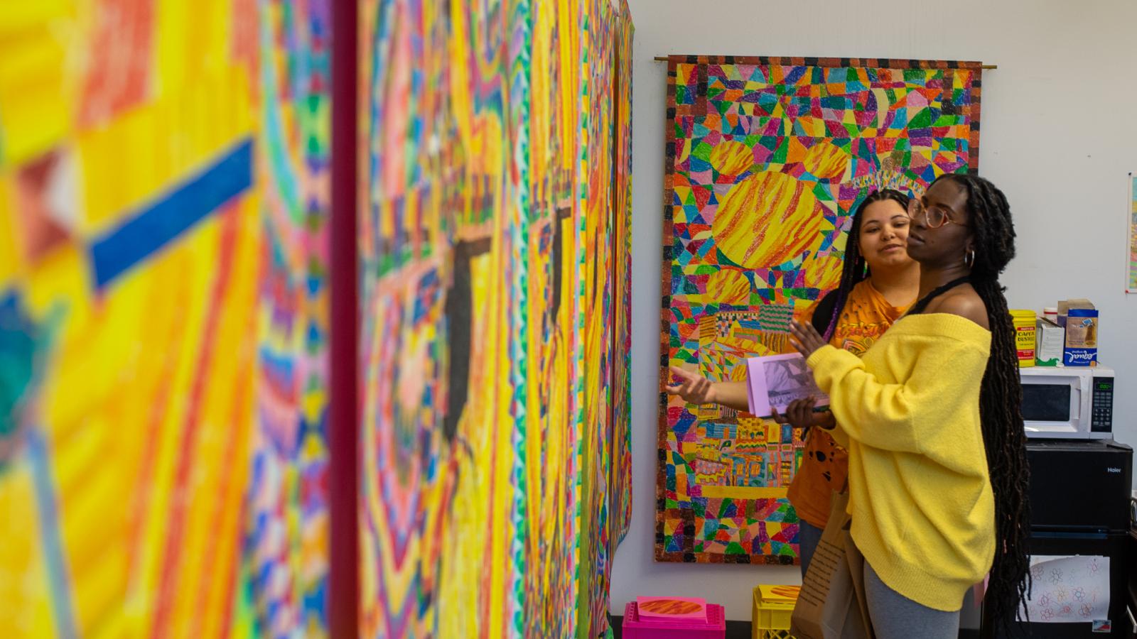 looking at colorful art on the wall